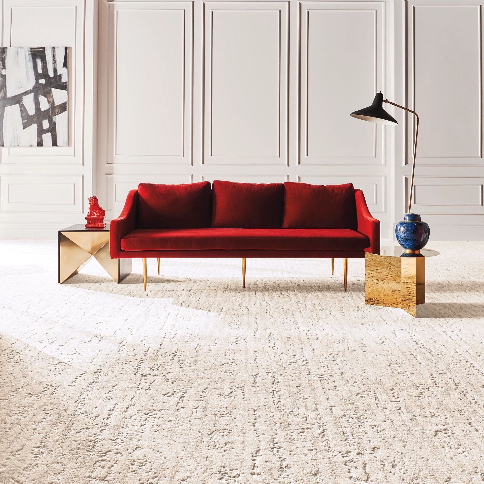 Bright living room with a red velvet couch and beige textured nylon carpet from Capitol Carpet in Dalton, GA